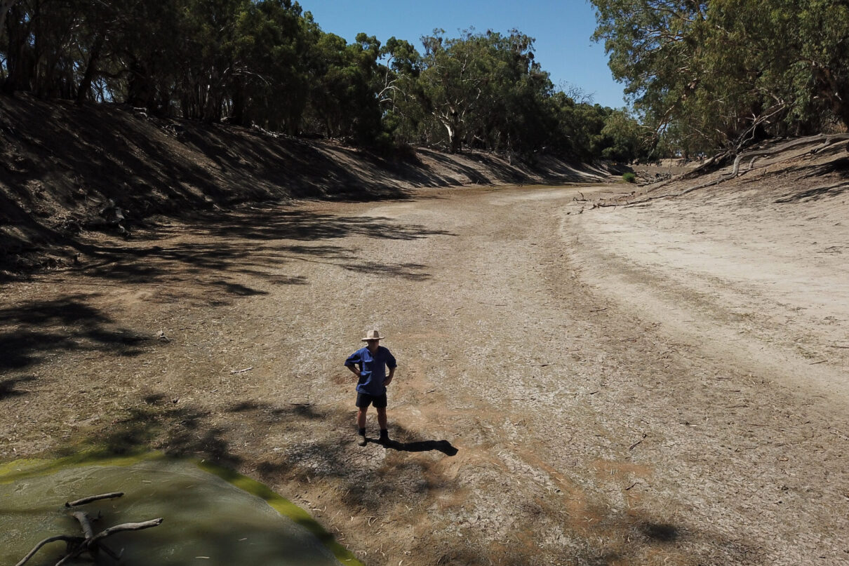 Sheep farmer Wayne Smith stands in the dry river bed of the Darling River on his property near Pooncarie, Thursday, February 14, 2019. Farmers along the Darling River and the Menindee Lakes are under increasing pressure in recent weeks due to poor water flow that has been caused by the continuing drought affecting more than 98% of New South Wales. (AAP Image/Dean Lewins)