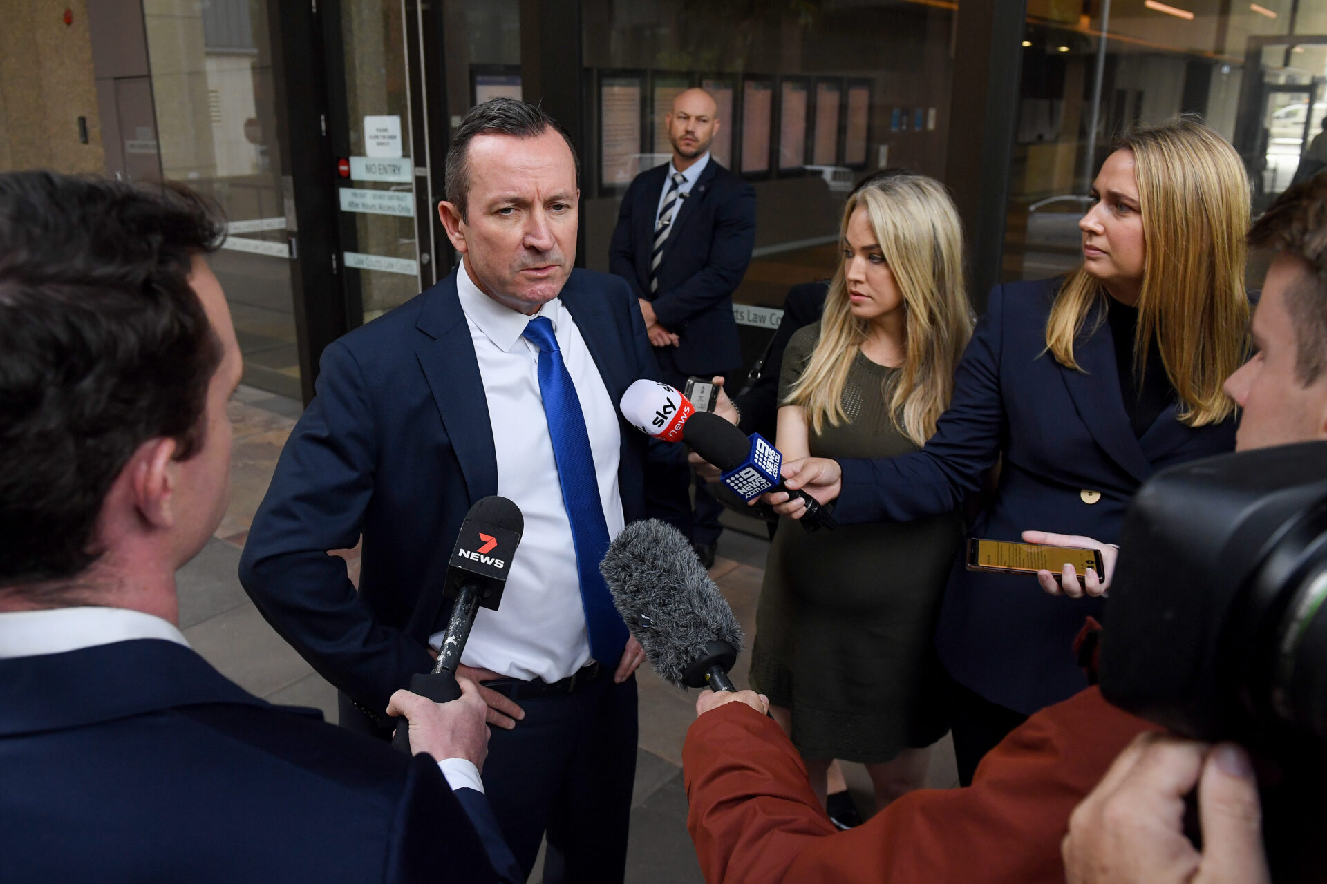 Former WA Premier Mark McGowan (left) speaks to the media as he arrives at the Federal Court of Australia in Sydney, Wednesday, March 9, 2022. Businessman Clive Palmer is suing West Australian Premier Mark McGowan claiming public comments, including labelling him the "enemy of West Australia", made in July 2020 had damaged the Queensland businessman's reputation. (AAP Image/Bianca De Marchi) 