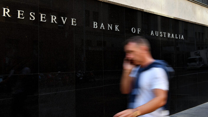 A pedestrian walks past the Reserve Bank of Australia (RBA) building in Sydney, Tuesday, February 4, 2020.