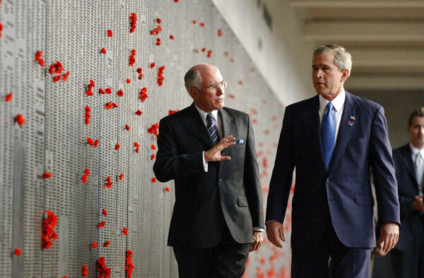 Canberra, October 23, 2003. United States President George W Bush visit to Canberra: US President George W Bush (left) and the Australian Prime Minister John Howard at the Australian War Memorial in Canberra today inspecting the roll of honour in the eastern cloisters. (AAP Image/Mick Tsikas/POOL)