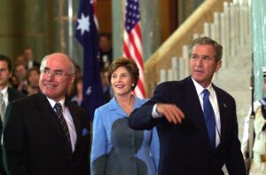 Canberra, October 23, 2003. United States President George Bush visit to Canberra: US President George W Bush (right) and wife Laura (C) walk with Australian Prime Minister John Howard at a welcome ceremony at Parliament House in Canberra today. Mr Bush later addressed a joint sitting of the Australian Parliament. (AAP Image/Alan Porritt/POOL)