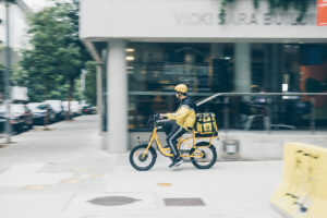 Sydney, Australia - December 14, 2019: EASI food deliverer on bicycle. EASI is a popular food delivery service in Australia, now a billion-dollar industry in Australia.