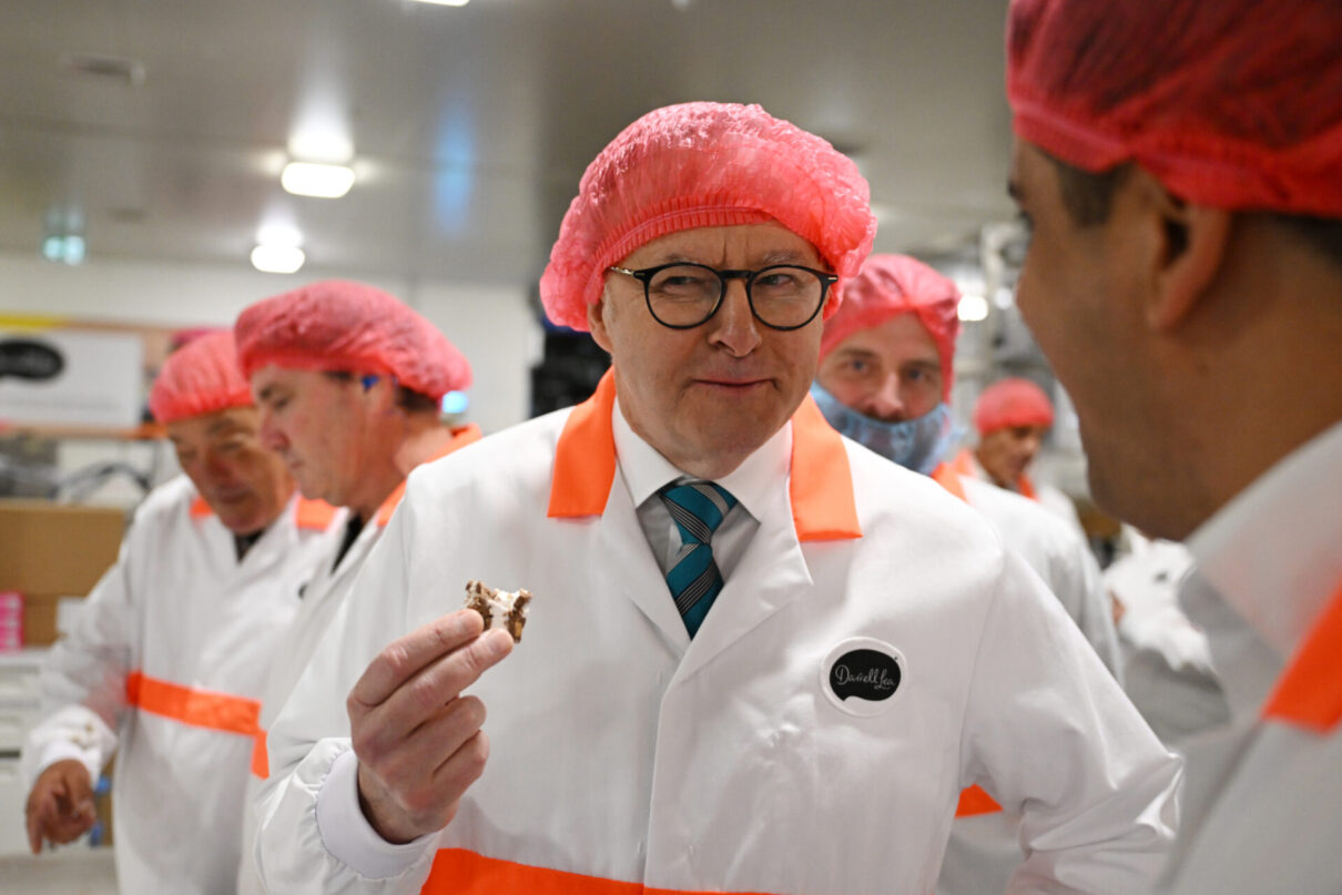 Prime MInister Anthony Albanese (centre) samples a fresh from the over Rockylea Road during a visit to the Darrell Lea confectionary factory in Ingleburn, Sydney, Wednesday, November 1, 2023