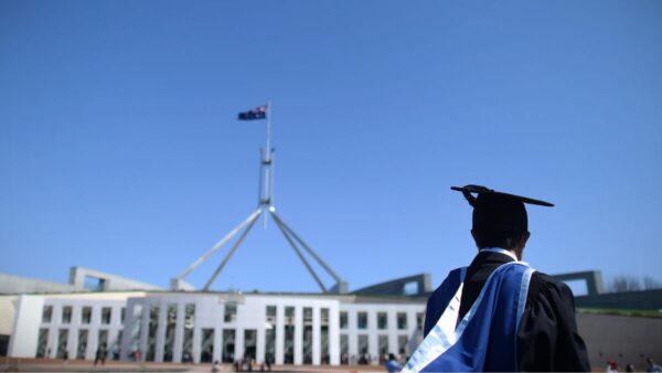 A university graduate is seen outside Parliament House in Canberra, Thursday, Oct. 1, 2015. The Turnbull government today announced it would drop planed university deregulation reforms