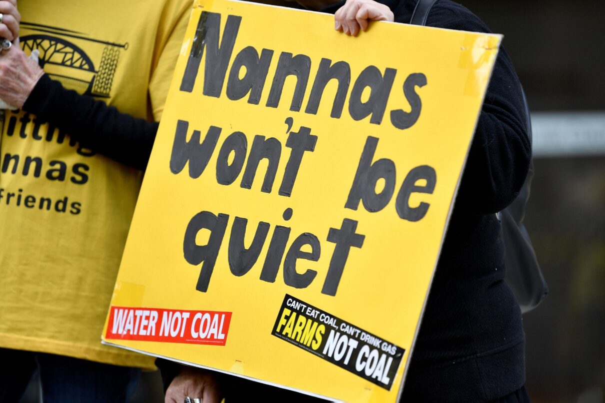 Members of the Knitting Nannas hold placards during a press conference outside the NSW Supreme Court in Sydney, Thursday, October 13, 2022. Climate-impacted 'Knitting Nannas' are launching a constitutional challenge to new NSW anti-protest laws.