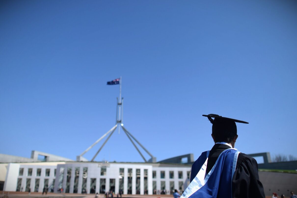A university graduate is seen outside Parliament House in Canberra, Thursday, Oct. 1, 2015. The Turnbull government today announced it would drop planed university deregulation reforms