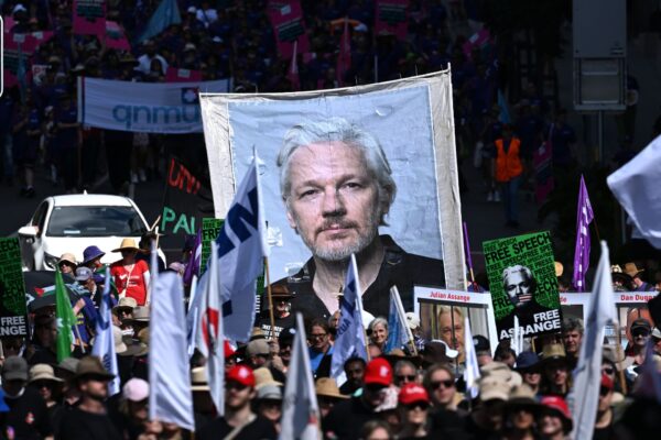 A portrait of Julian Assange is seen being carried by supporters as Union members and other people participate in a march as part of Labour Day celebrations in Brisbane, Monday, May 6, 2024. Labour Day celebrations, organised by Queensland Unions, invites union members and their families to gather with their union and celebrate the ongoing achievements of Queensland workers and the strength of their unions.