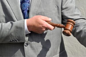 A gavel is held by an auctioneer as buyers bid on a house, during a live auction in Sydney, Saturday, August 10, 2024.