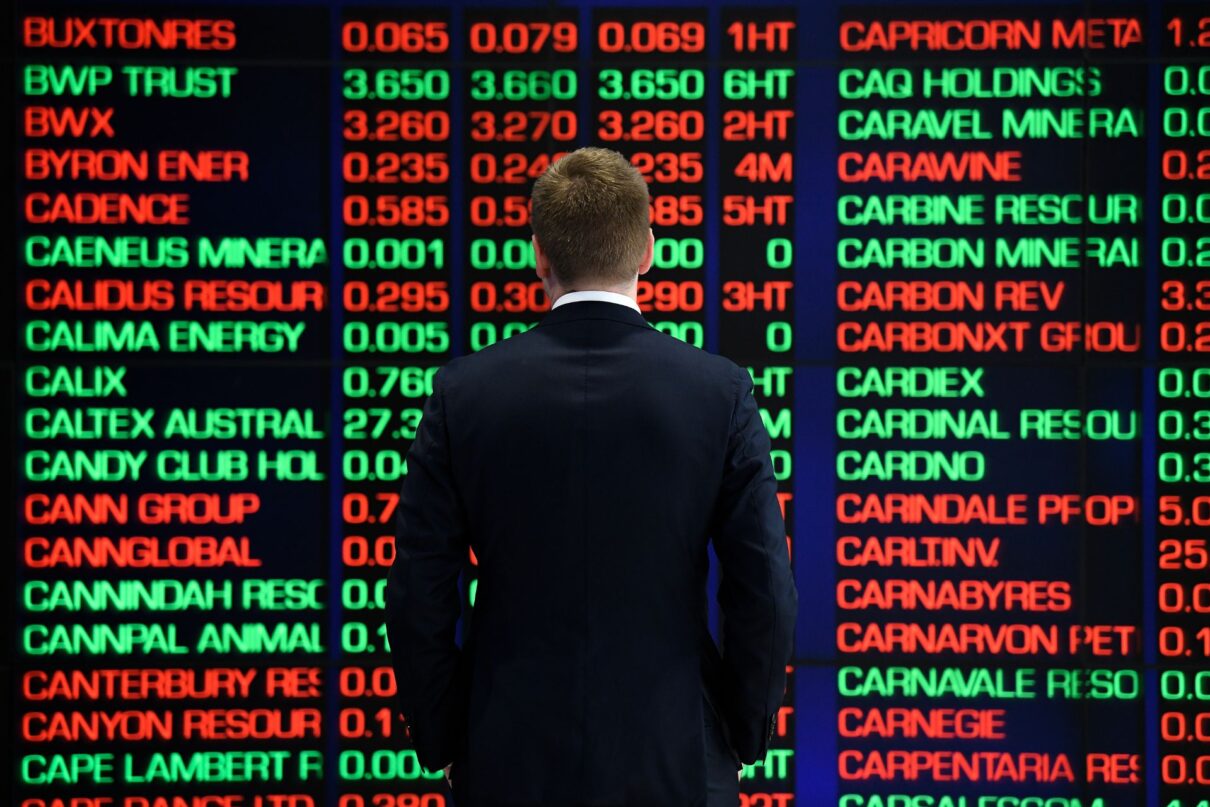 A man is seen looking at the digital market boards at the Australian Stock Exchange (ASX) in Sydney, Monday, March 9, 2020. The Australian share market has had its worst morning since the Global Financial Crisis in 2008, as the escalation of the coronavirus stifles international economic growth.