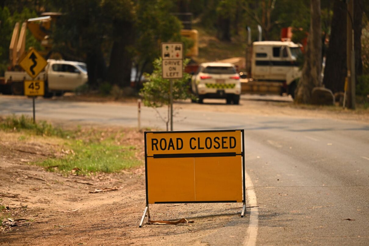 A road closed sign is seen in Halls Gap, Victoria, Sunday, December 22, 2024. Immediate evacuation orders are in place for towns across Victoria as out-of-control blazes and sweltering temperatures begin Australia's bushfire season.