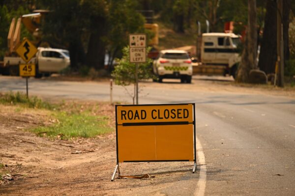 A road closed sign is seen in Halls Gap, Victoria, Sunday, December 22, 2024. Immediate evacuation orders are in place for towns across Victoria as out-of-control blazes and sweltering temperatures begin Australia's bushfire season.