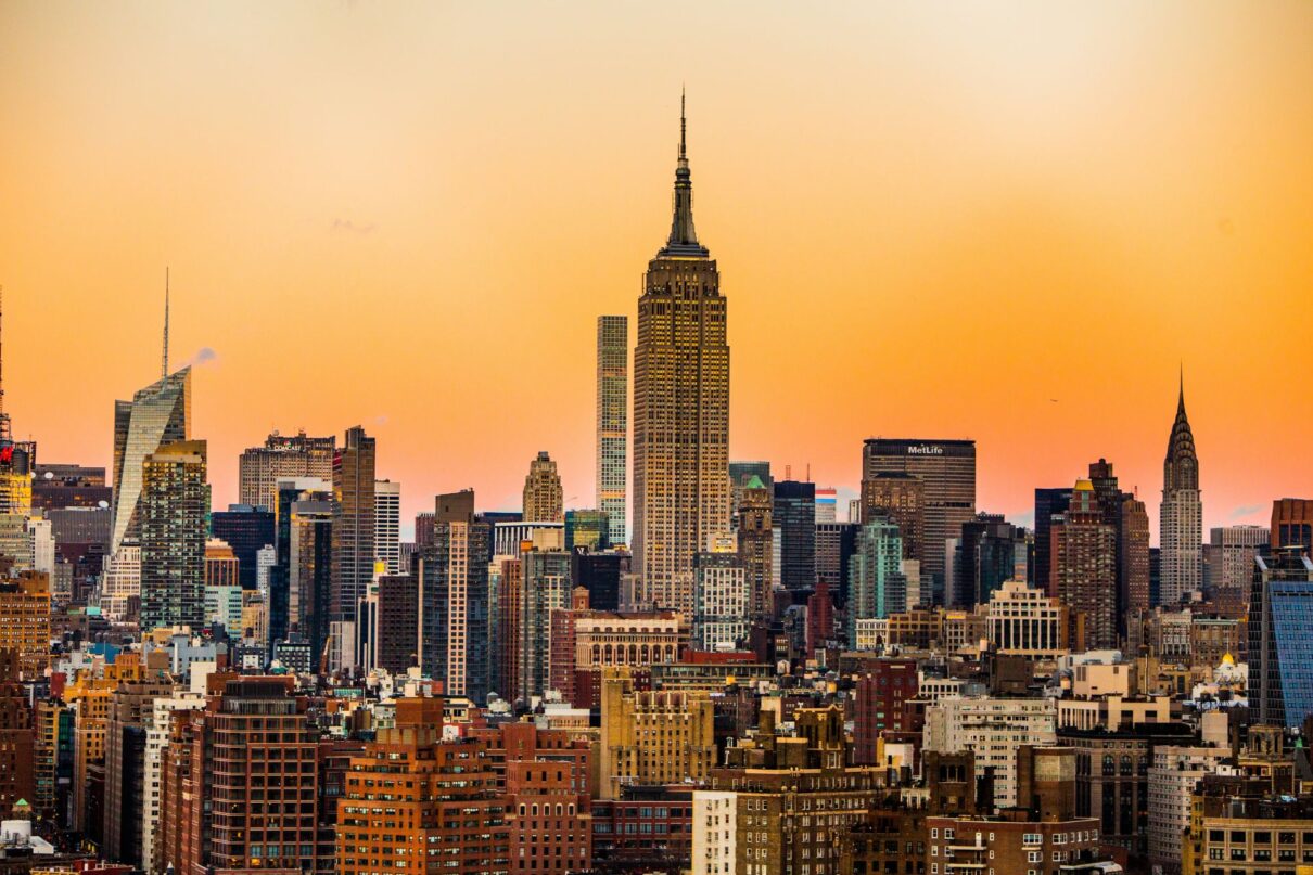 Landscape photo of New York Empire State Building with orange sky.