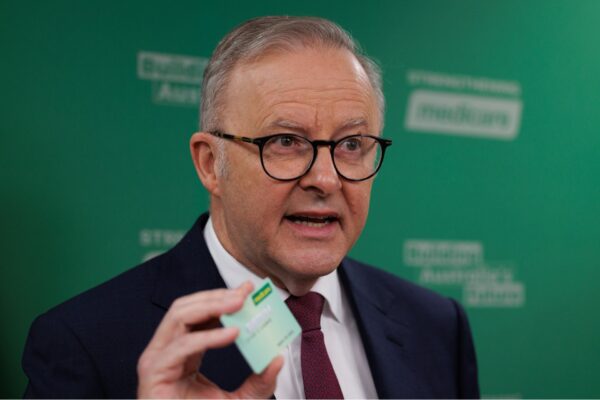 Prime Minister Anthony Albanese holds up a Medicare card while speaking to the media during a press conference at the Chatswood Medical Centre in Sydney, Tuesday, February 25, 2025.