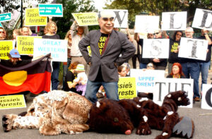 A man wearing a John Howard mask stands over an 'owl' and a 'quoll' during a protest against the government's forest plan outside Prime Minister John Howard's residence in Kirribilli, Sydney