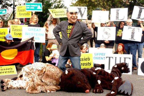 A man wearing a John Howard mask stands over an 'owl' and a 'quoll' during a protest against the government's forest plan outside Prime Minister John Howard's residence in Kirribilli, Sydney
