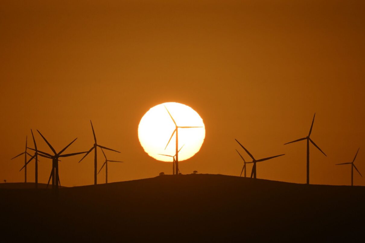 The sun rises over power-generating wind turbines at the Capital Wind Farm, 40km east of Canberra, Tuesday, March 18, 2025.